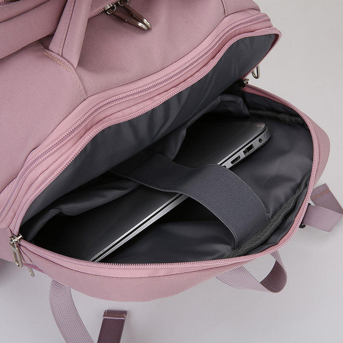 TAKT 20 under-seat cabin backpack in Rose, padded laptop sleeve with a laptop in place